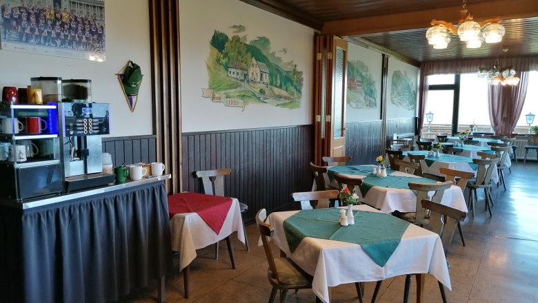 Restaurant, © Wiener Alpen Innenansicht eines Restaurants mit Holzmöbeln und Tischdecken.