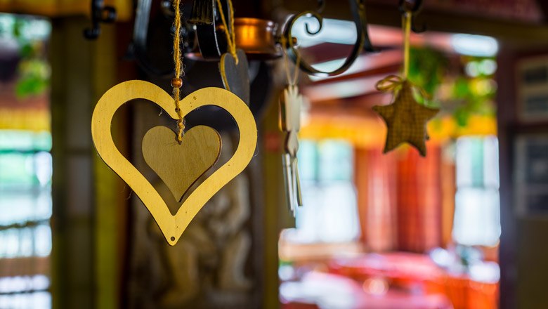 Holzherz und Stern als Dekoration in einer gemütlichen Hütte.